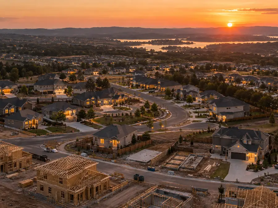 Aerial view of a new neighbourhood at sunset with homes under construction